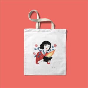 Tote bag con una ilustración de una mujer leyendo.