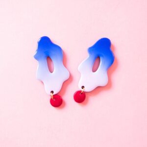 Pendientes amoeba con estampado degradado rosa chicle y azul eléctrico y cuenta redonda mini en rojo.